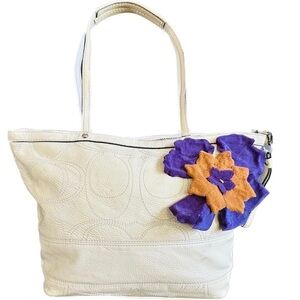 Coach patent leather purse with green interior and purple saddle tan flower.cute
